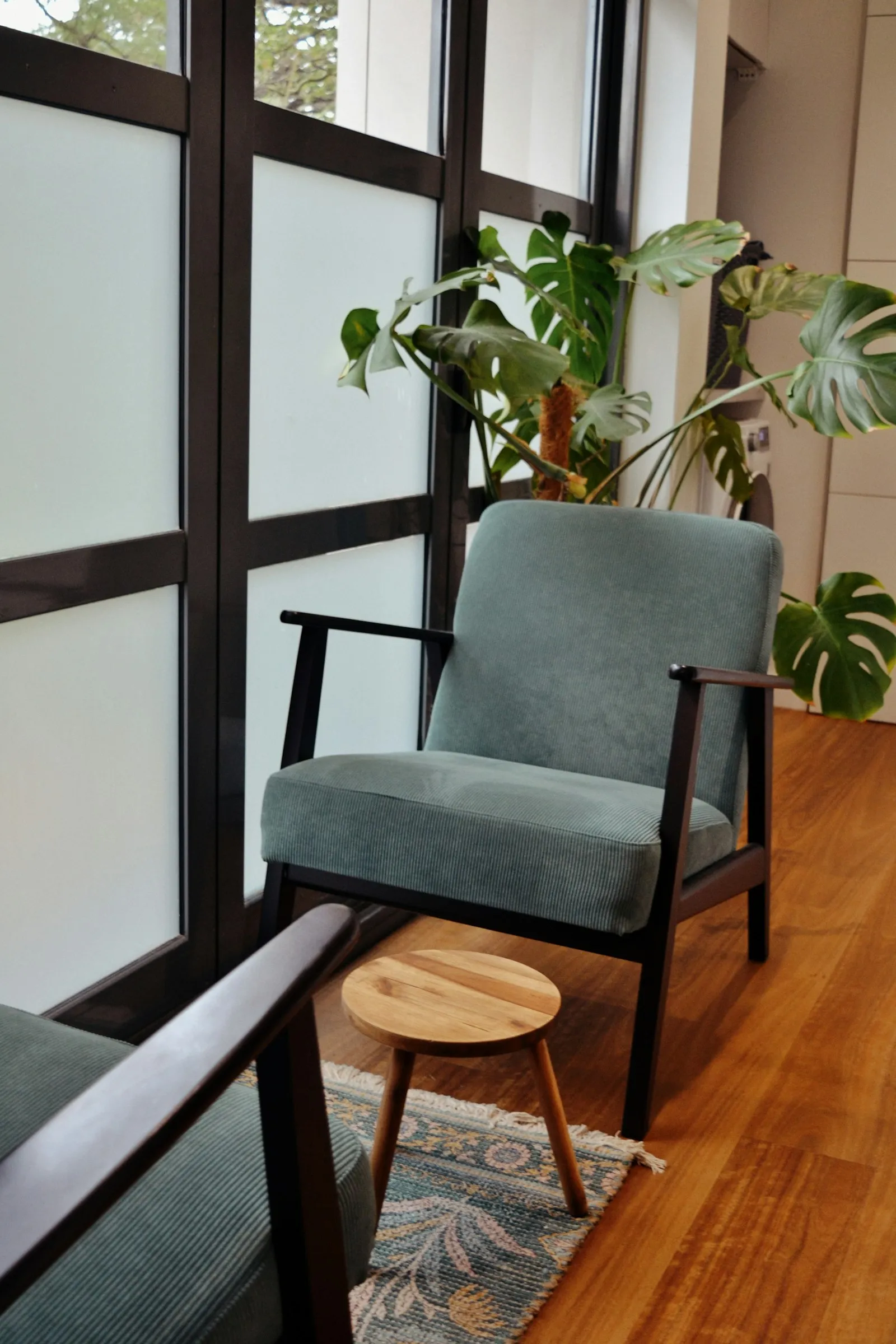A cozy reading corner with a chair and a potted plant